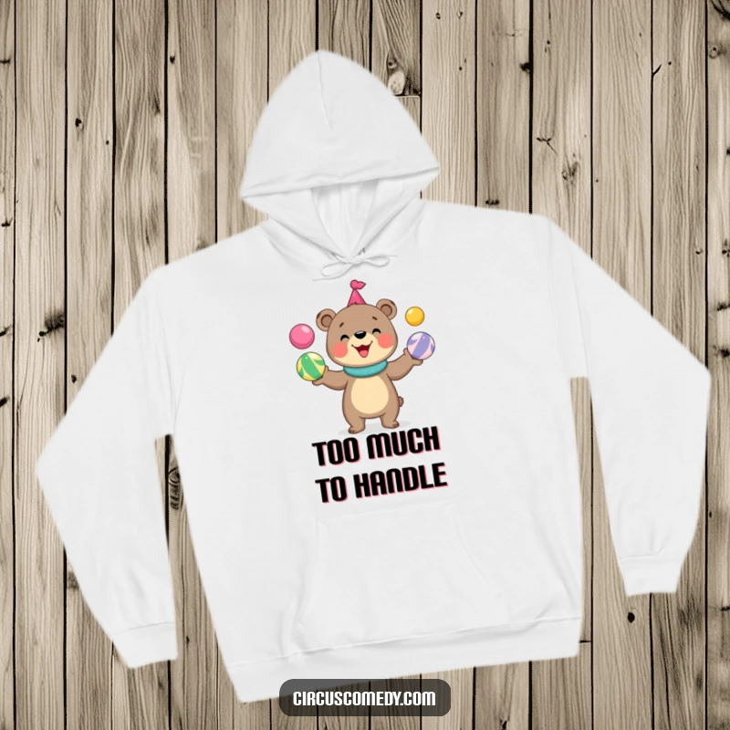 Funny bear hoodie featuring a cute, grinning bear masterfully juggling a vibrant assortment of circus balls, radiating pure joy.