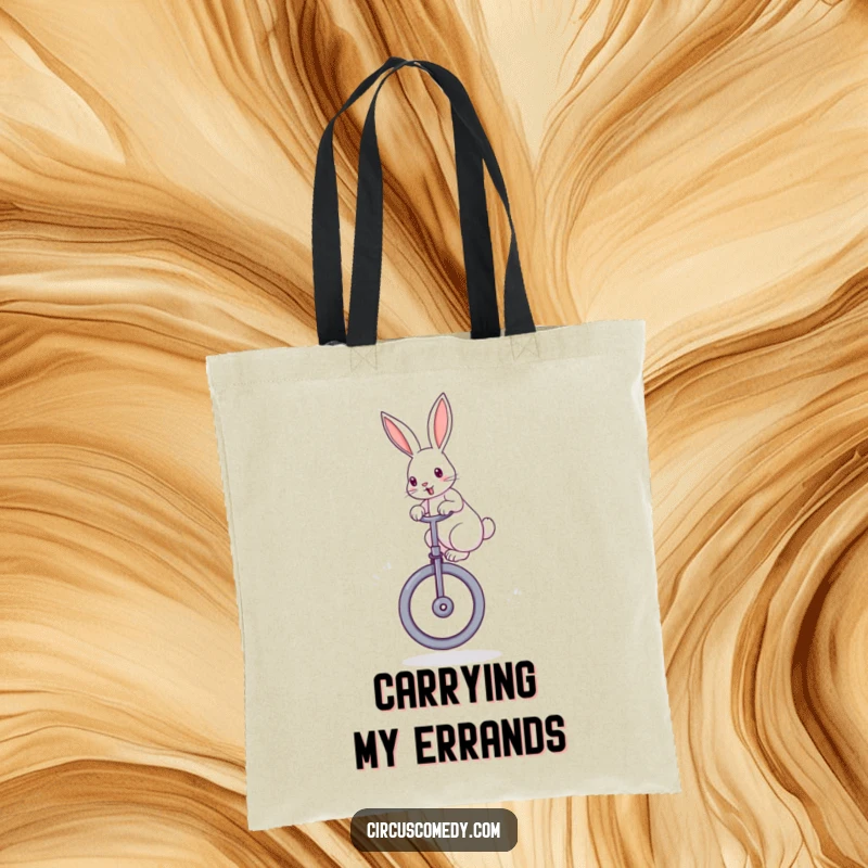 Funny rabbit tote bag showing a determined rabbit with perked ears, skillfully balancing on a large unicycle, a practical and fun accessory.