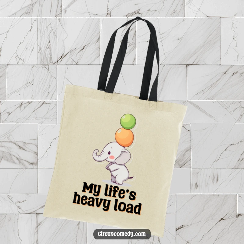 Funny Focused Elephant Tote Bag: A small elephant balances colorful balls on its trunk with intense focus, a funny and practical tote.